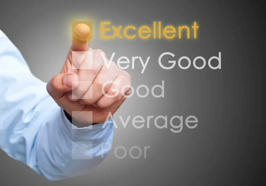 A person is touching an excellent word on the screen.