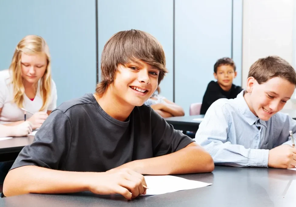 A group of people sitting at tables with papers.
